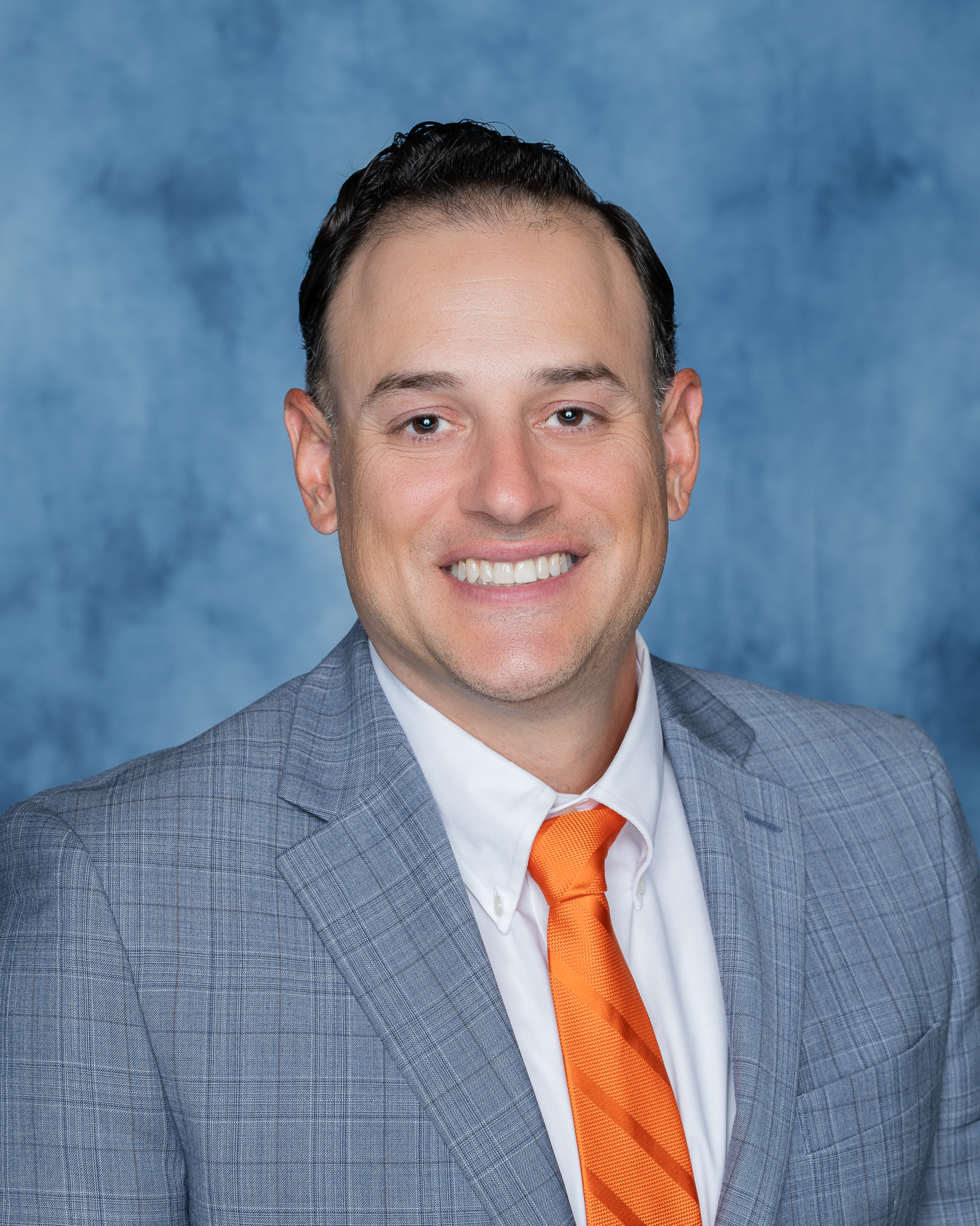Corporate headshot of FISERV Associate, against a clean backdrop, exuding confidence and approachability. Crisp attire and a friendly smile convey a polished and competent professional image, perfect for LinkedIn profiles and business websites.