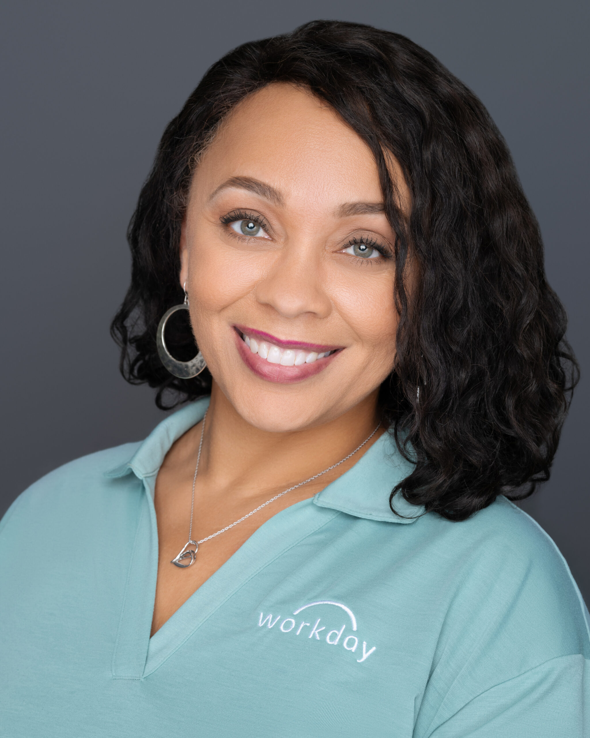 Corporate Headshot of Workday associate with a solid grey background. Corporate headshot captured by PWG Lens.