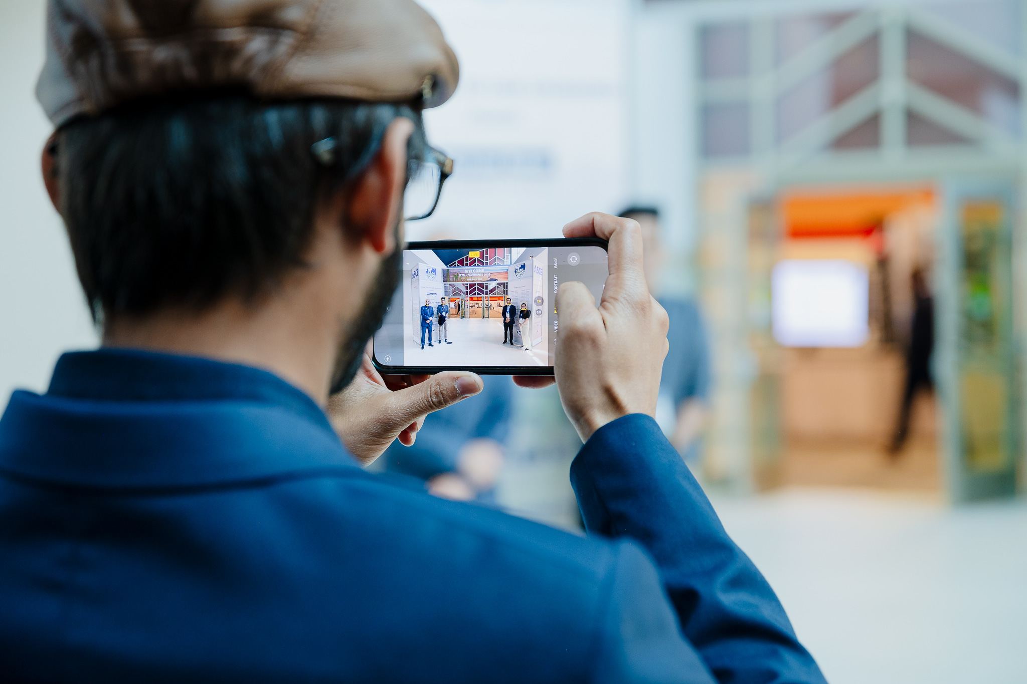 Conference attendees engaged in conversation around a table, networking and discussing during a conference in Arizona - Captured by PWG Lens