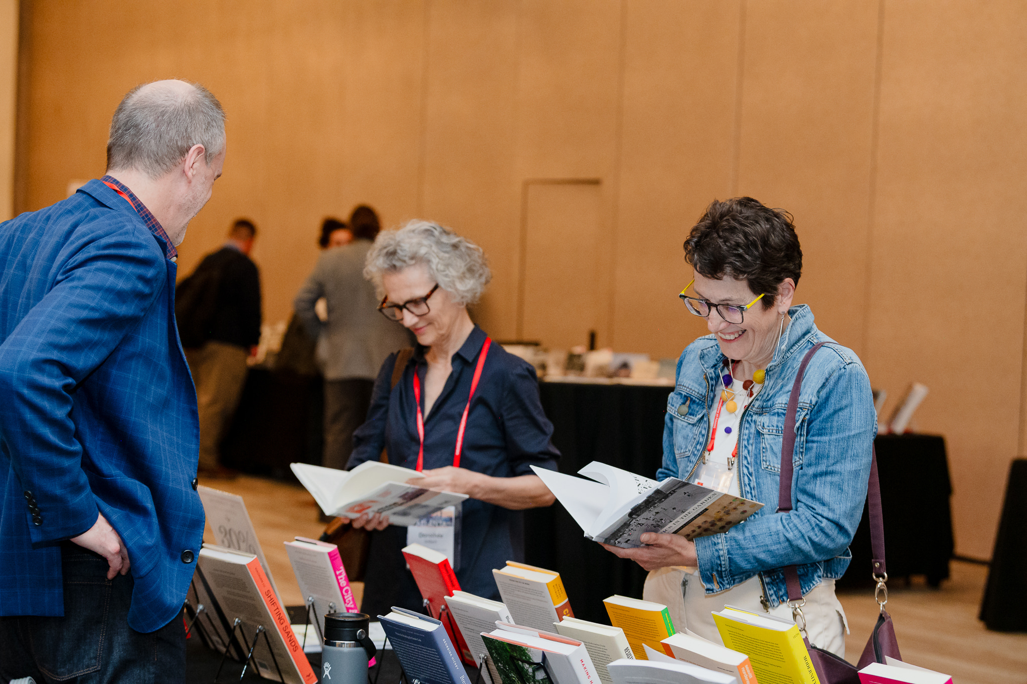 Professional conference photography documenting networking and exhibitor engagement.